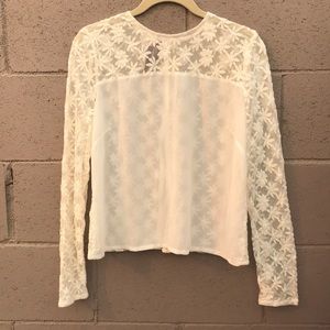 Sheer cream color top.  Buttons are on the back